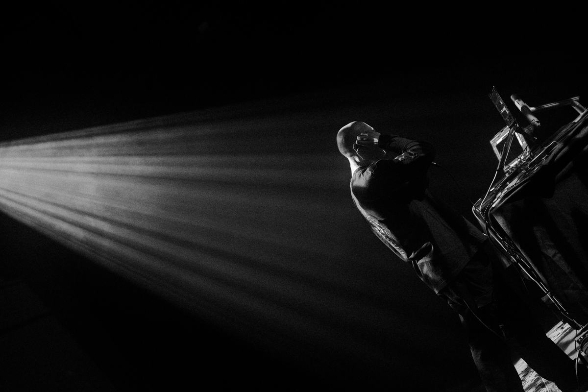 A dancer in a beam of projected light