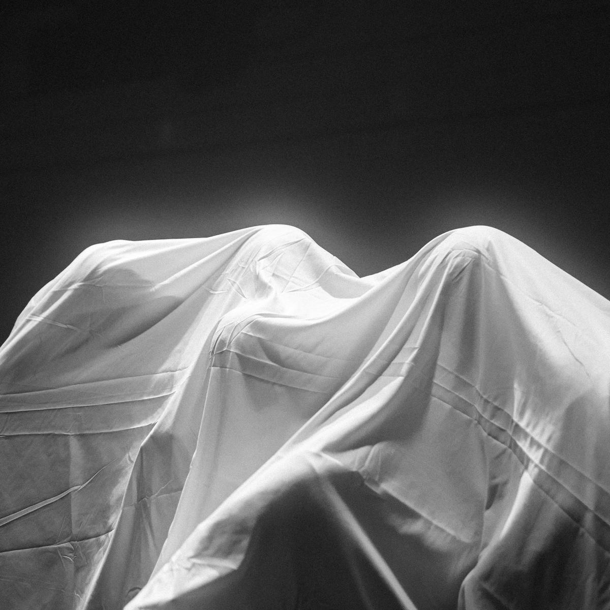 Dancers under white fabric
