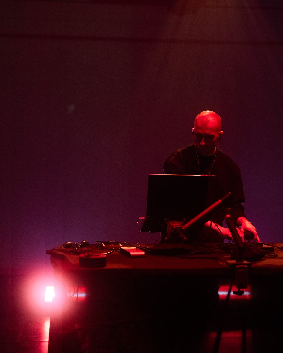 Factor Eight at the desk in red light