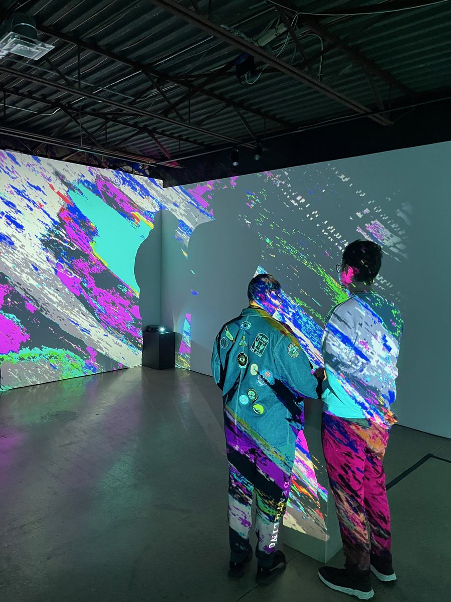 Visitors inside Catalyst, dance projected on the walls