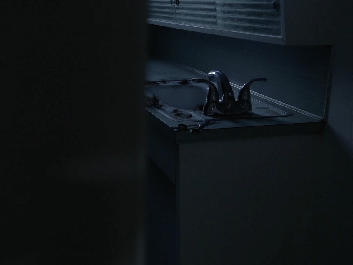 Frame from #nothinglastsforever: a sink in the dark