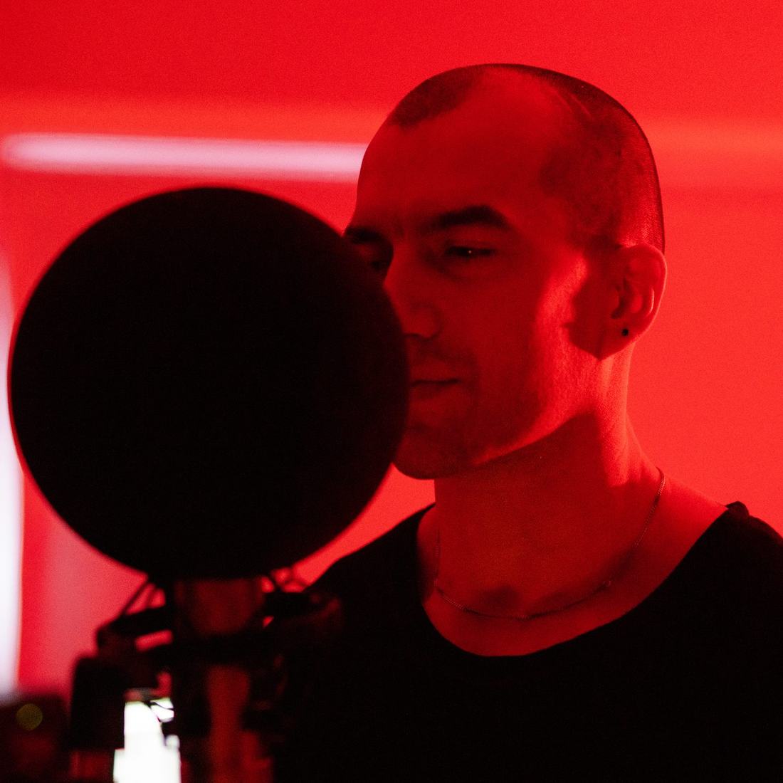 Recording vocals in a red-lit studio
